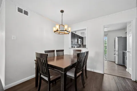 a view of a dining room with a table and chairs