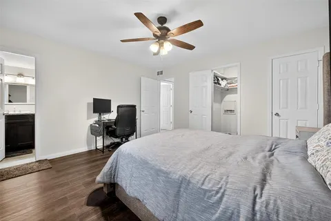 a bed room with a bed and a ceiling fan