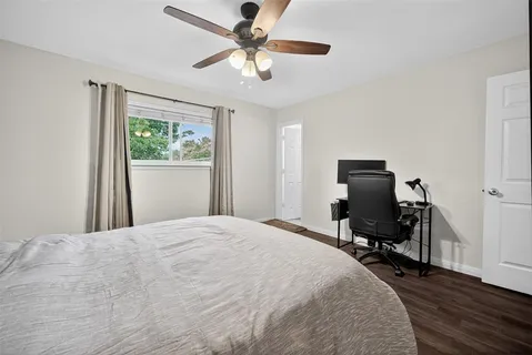 a bedroom with a bed dresser and a window
