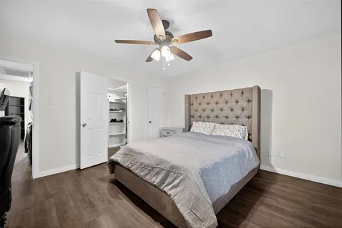 a bedroom with a bed and a ceiling fan