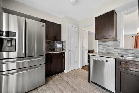 a kitchen with stainless steel appliances a refrigerator stove and sink