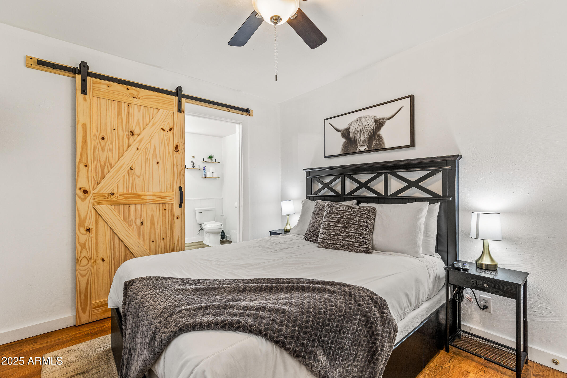 1159 Coyote Road Munds Park, AZ 86017 - Photo 12 of 22 a bedroom with a bed and painting on the wall