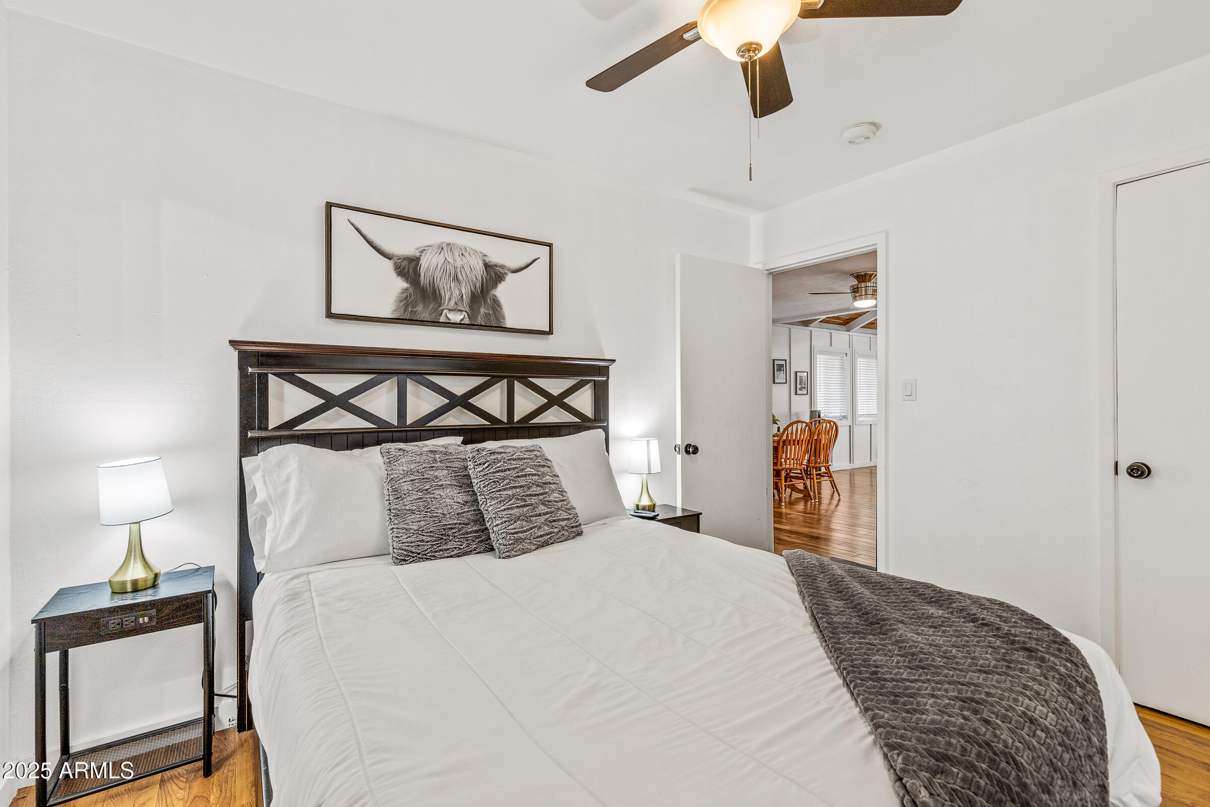 1159 Coyote Road Munds Park, AZ 86017 - Photo 14 of 22 a bedroom with a bed and wooden floor