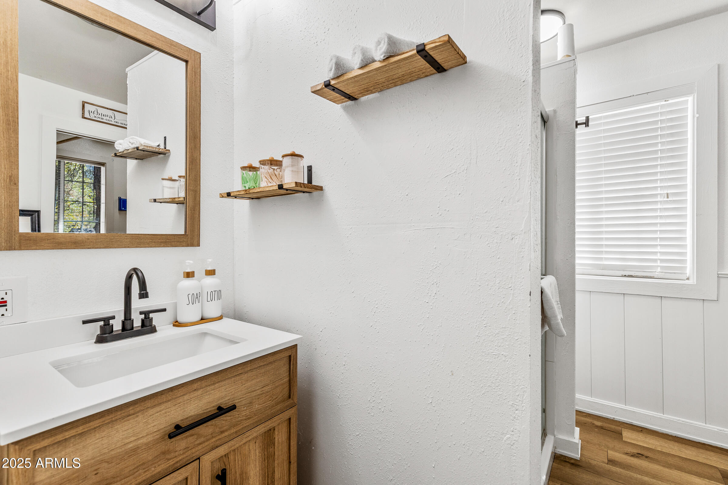 1159 Coyote Road Munds Park, AZ 86017 - Photo 15 of 22 a bathroom with a sink and a mirror