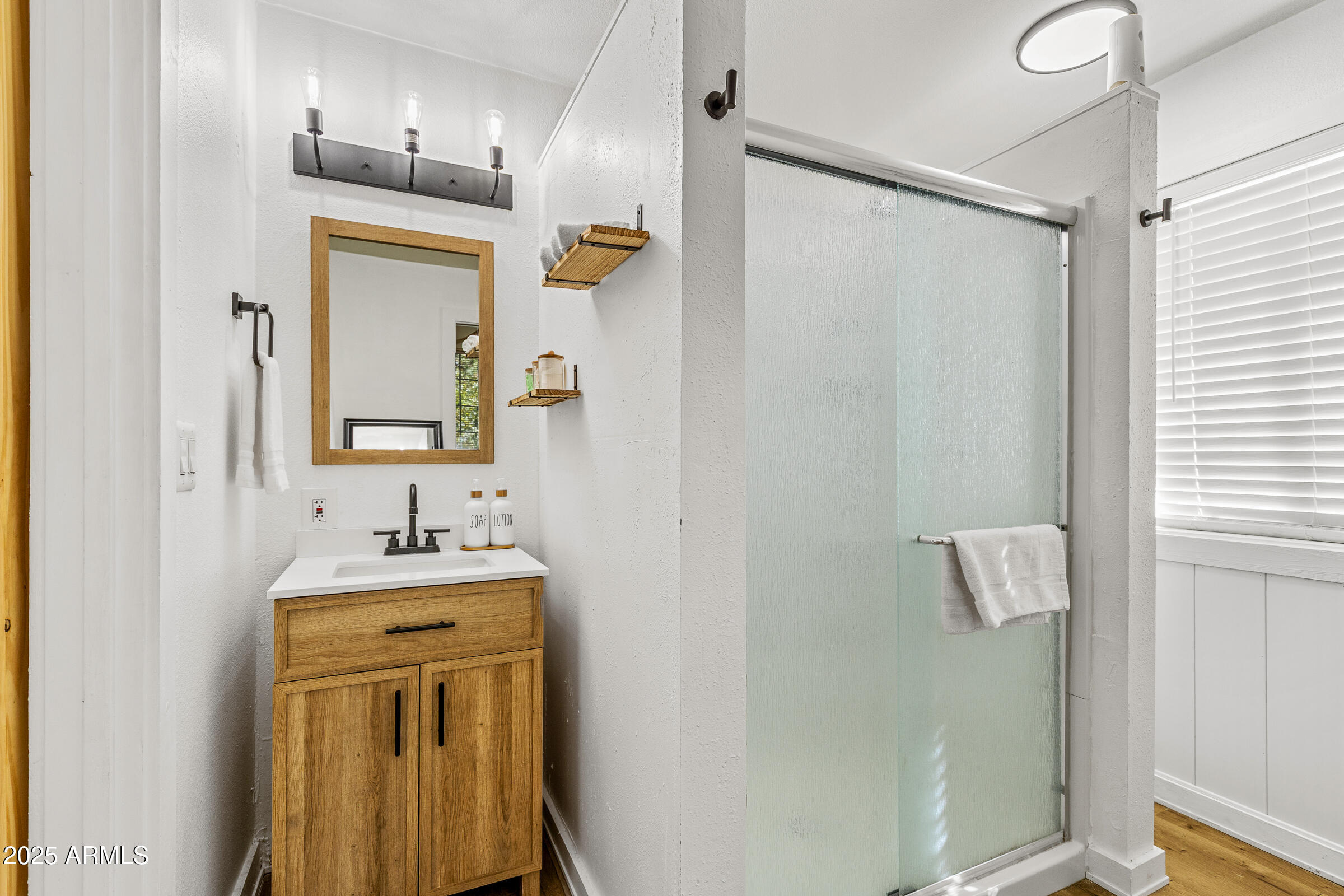 1159 Coyote Road Munds Park, AZ 86017 - Photo 16 of 22 a bathroom with a sink vanity and mirror