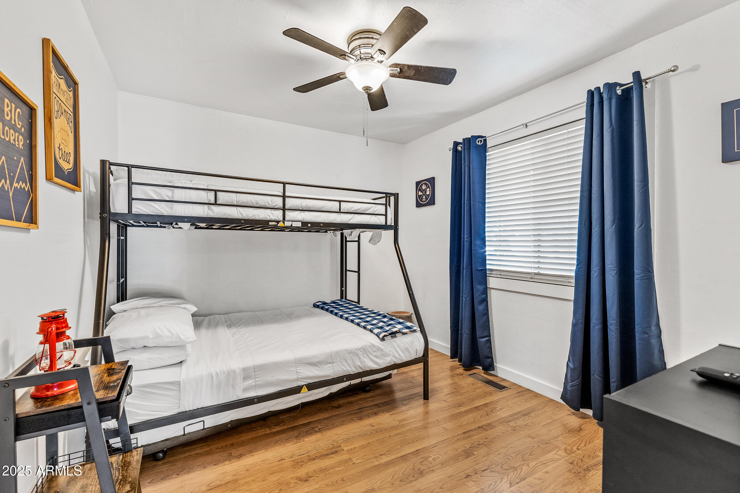 1159 Coyote Road Munds Park, AZ 86017 - Photo 17 of 22 a bedroom with a bed and a chandelier
