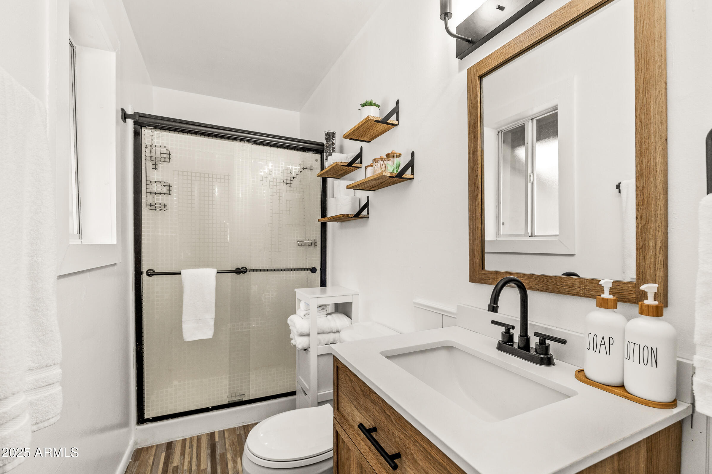 1159 Coyote Road Munds Park, AZ 86017 - Photo 19 of 22 a bathroom with a sink toilet and mirror