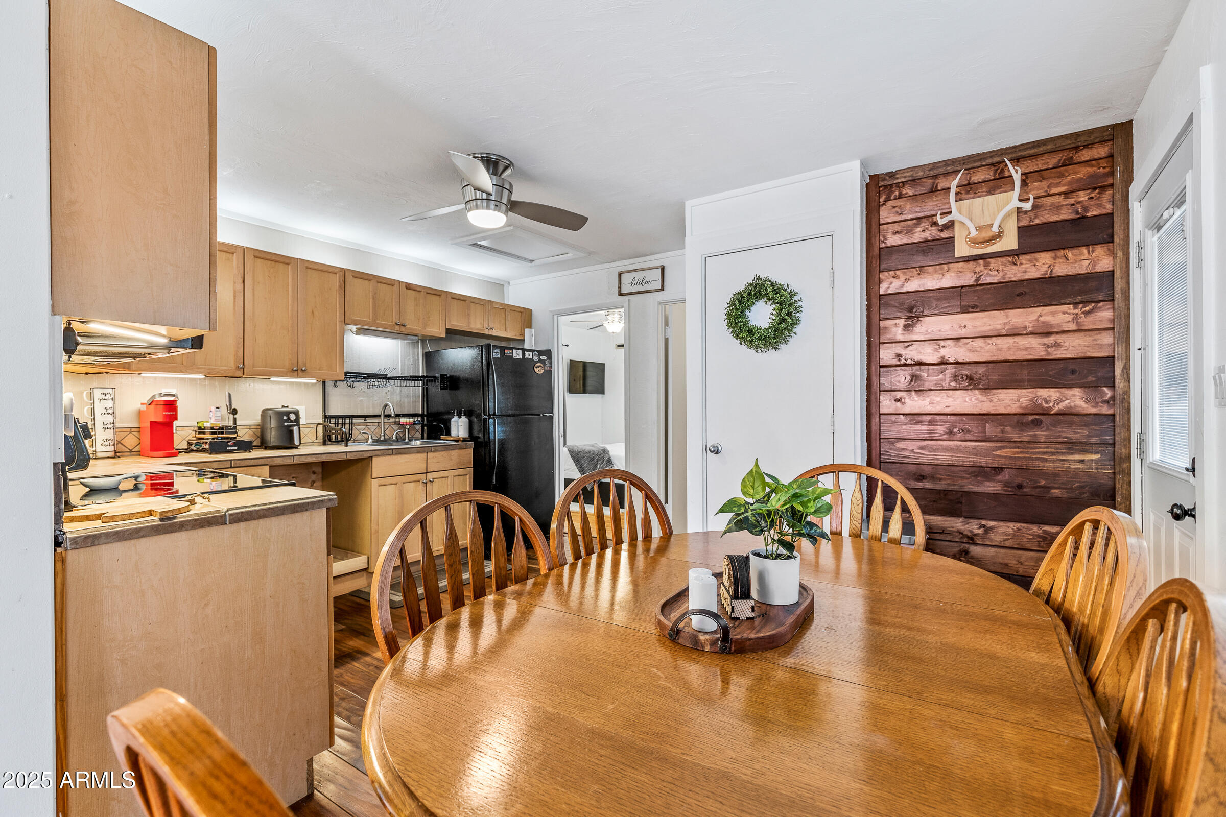 1159 Coyote Road Munds Park, AZ 86017 - Photo 10 of 22 a dinning room with stainless steel appliances furniture a window and a kitchen view