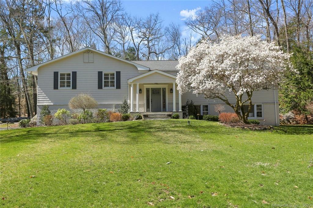 89 Musket Ridge Road Wilton, CT 06897 - Photo 1 of 1 a front view of a house with garden