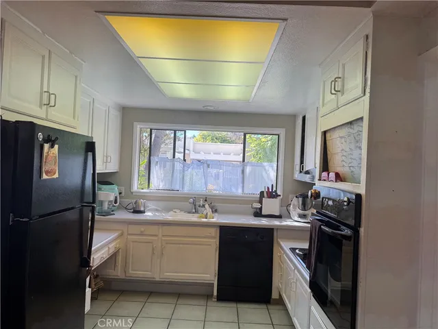 a kitchen with a sink appliances and cabinets