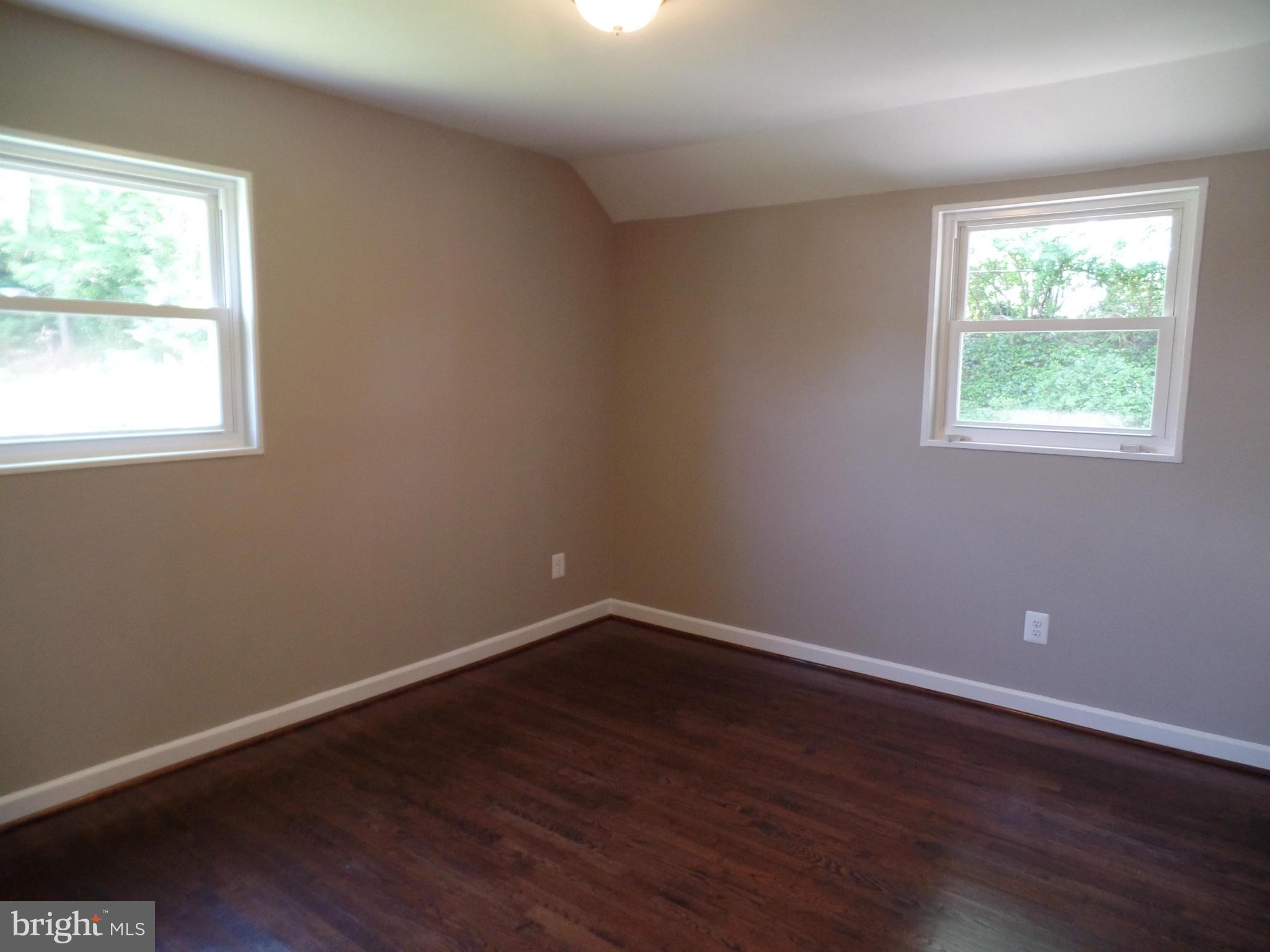 2822 Denley Place Silver Spring, MD 20906 - Photo 15 of 18 an empty room with wooden floor and windows