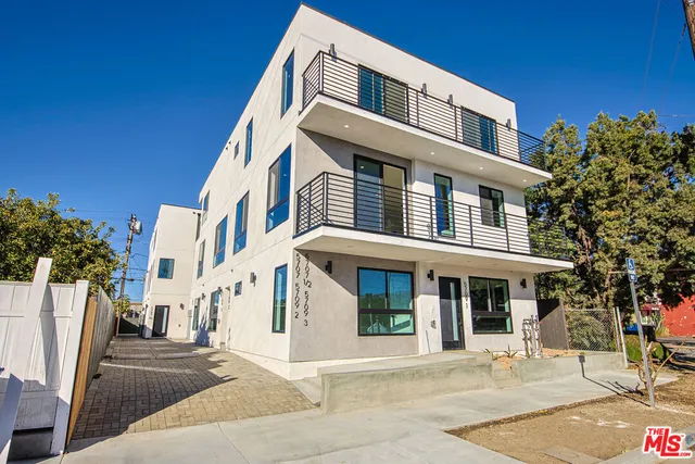 a front view of a building with a garden