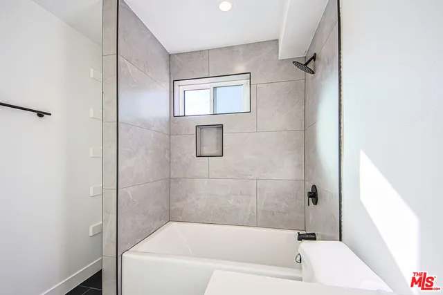 a kitchen with stainless steel appliances granite countertop a sink and a refrigerator