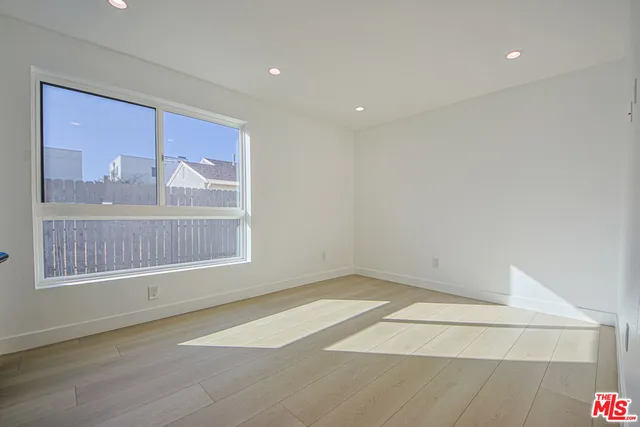 an empty room with painting and stairs