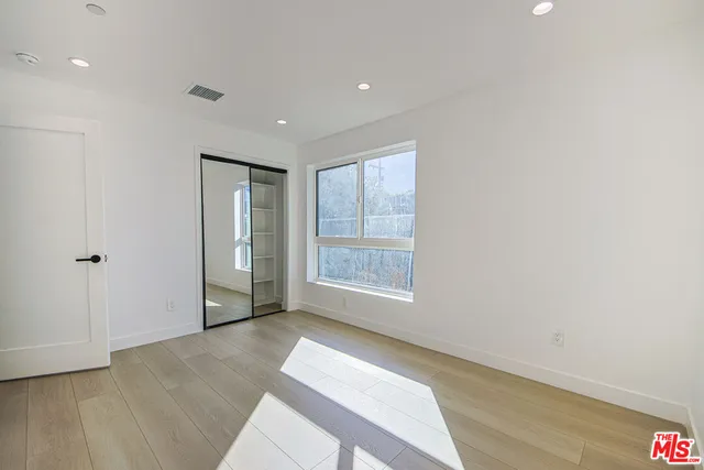 a bathroom with a toilet a sink a mirror a bathtub and vanity