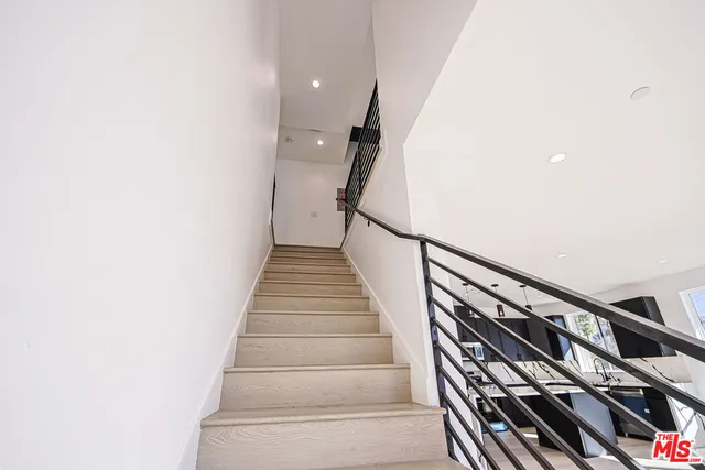 a view of a kitchen with a refrigerator a microwave and a sink