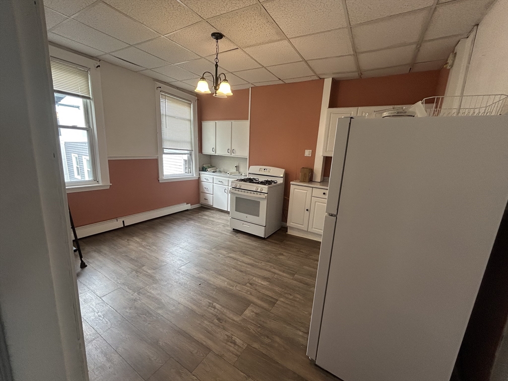 55 P Street, Unit 2 Boston, MA 02127 - Photo 11 of 34 a kitchen with a refrigerator and a stove top oven