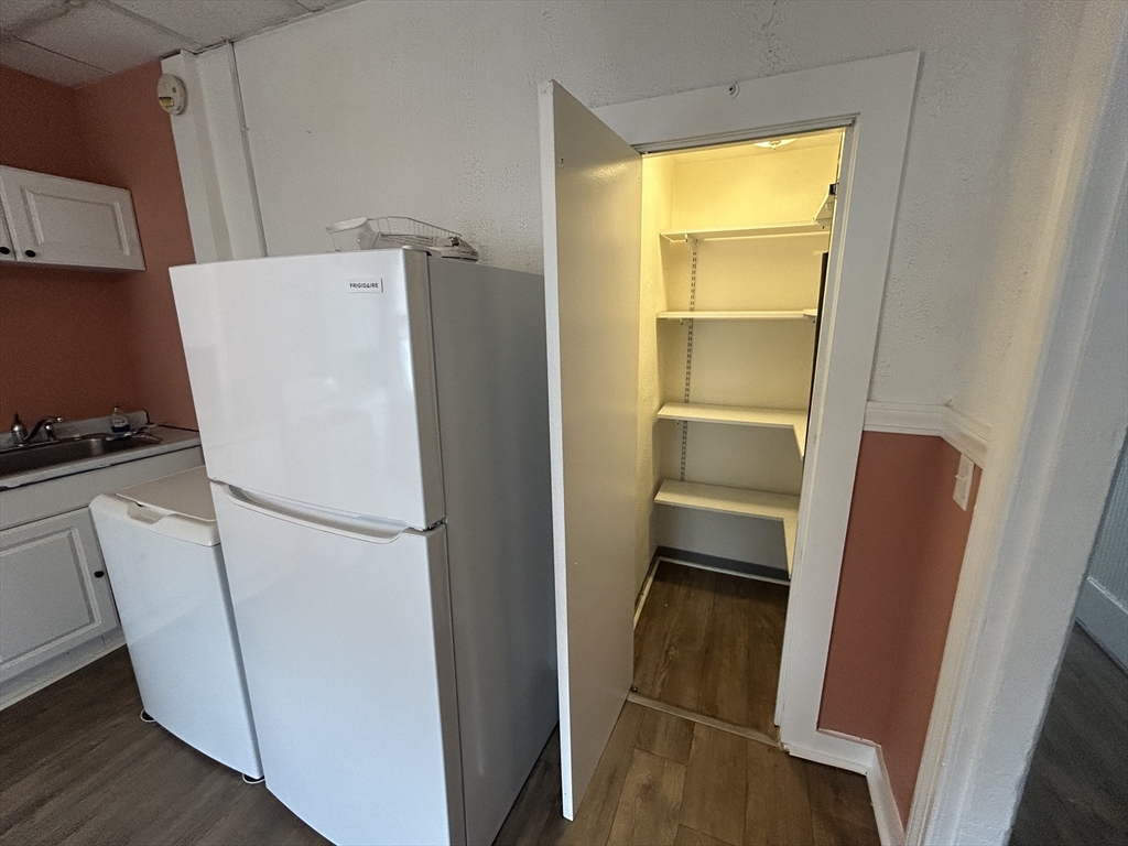 55 P Street, Unit 2 Boston, MA 02127 - Photo 16 of 34 a white refrigerator freezer and a stove sitting inside of a kitchen