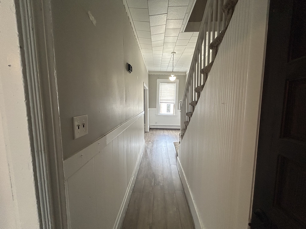 55 P Street, Unit 2 Boston, MA 02127 - Photo 17 of 34 a view of a hallway with wooden floor and staircase