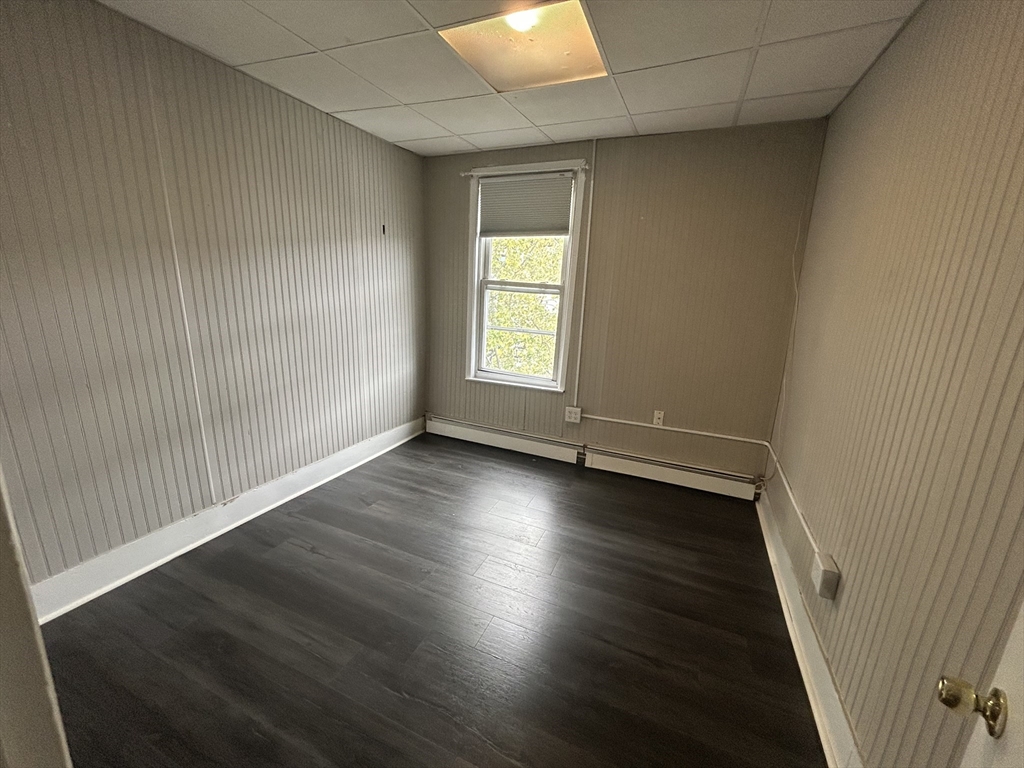 55 P Street, Unit 2 Boston, MA 02127 - Photo 20 of 34 an empty room with wooden floor and windows