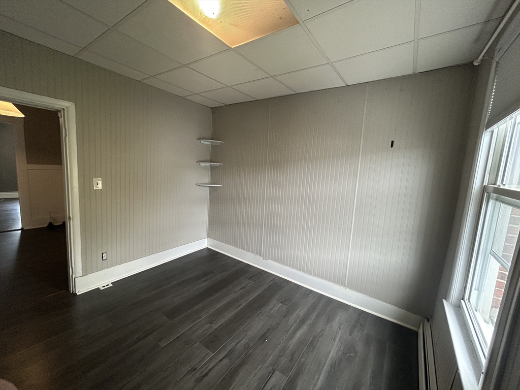 55 P Street, Unit 2 Boston, MA 02127 - Photo 21 of 34 an empty room with wooden floor and windows