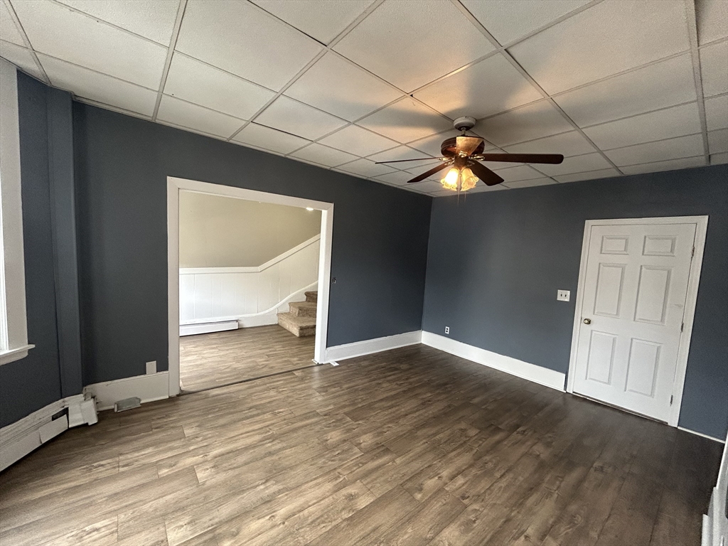55 P Street, Unit 2 Boston, MA 02127 - Photo 3 of 34 an empty room with wooden floor and chandelier fan