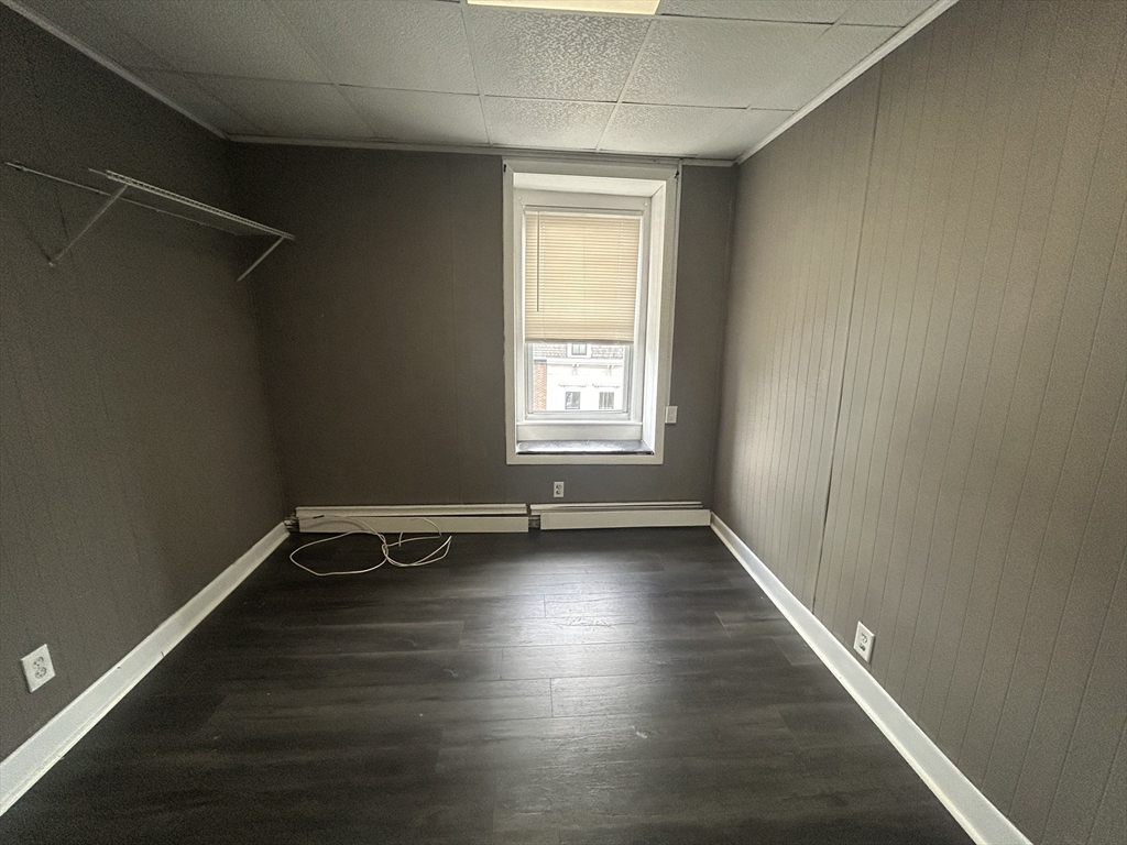 55 P Street, Unit 2 Boston, MA 02127 - Photo 33 of 34 an empty room with wooden floor and windows