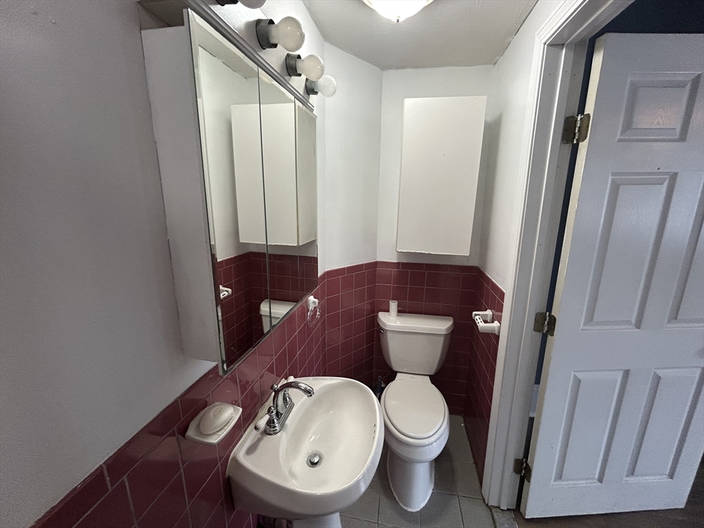 55 P Street, Unit 2 Boston, MA 02127 - Photo 5 of 34 a bathroom with a toilet and a mirror