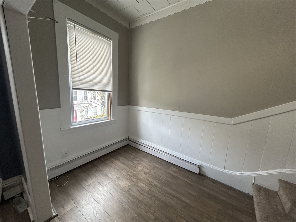 55 P Street, Unit 2 Boston, MA 02127 - Photo 8 of 34 an empty room with wooden floor and windows