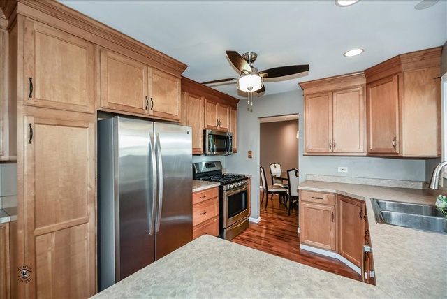 148 Timberlane Road Matteson, IL 60443 - Photo 12 of 23 a kitchen with stainless steel appliances granite countertop a refrigerator a sink a stove and white cabinets