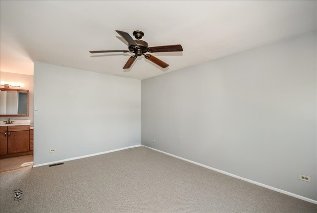 148 Timberlane Road Matteson, IL 60443 - Photo 14 of 23 an empty room with a ceiling fan and a window