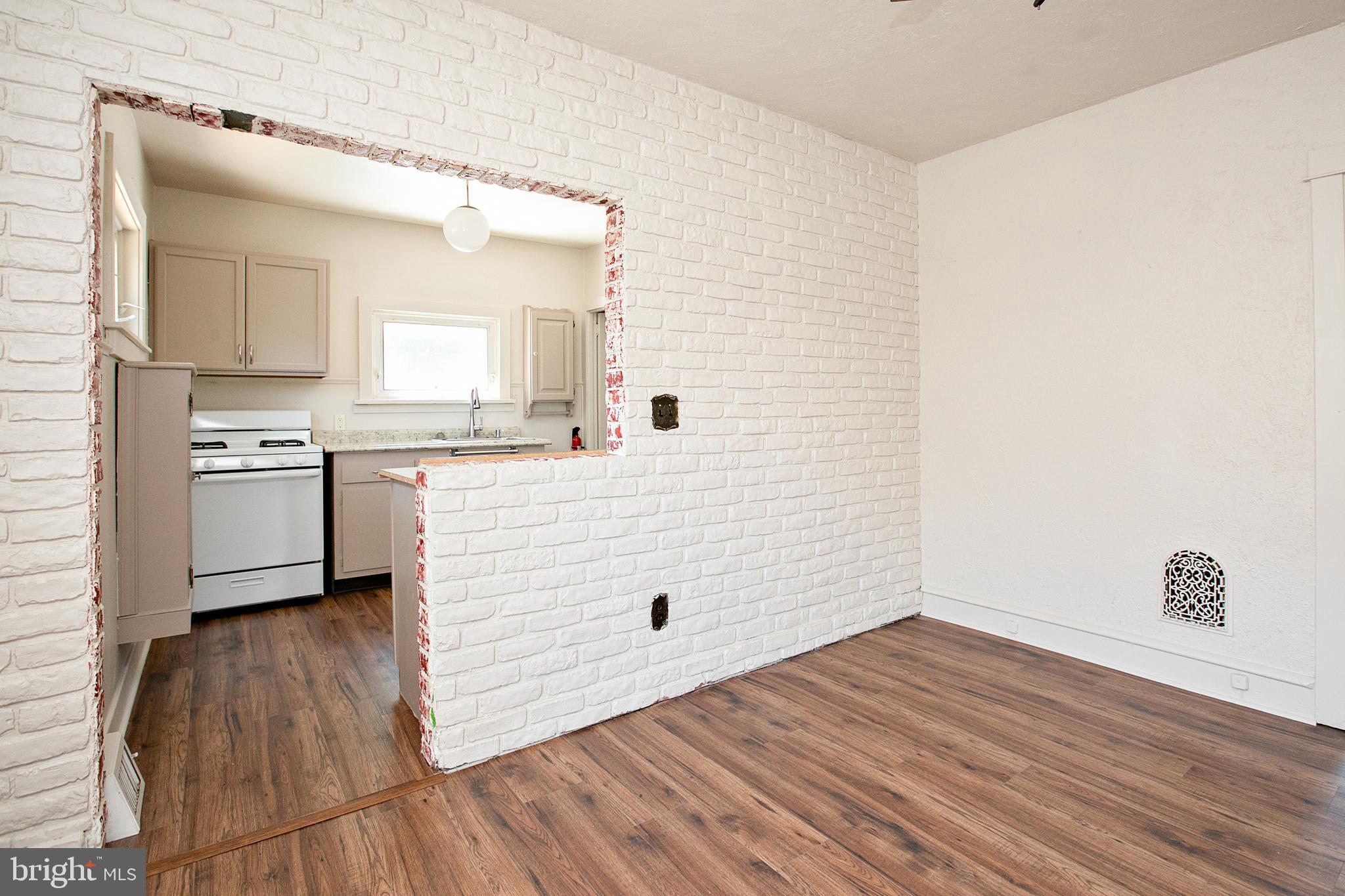34 Valley Road Mount Ephraim, NJ 08059 - Photo 13 of 39 a kitchen with a wooden floor and white stainless steel appliances