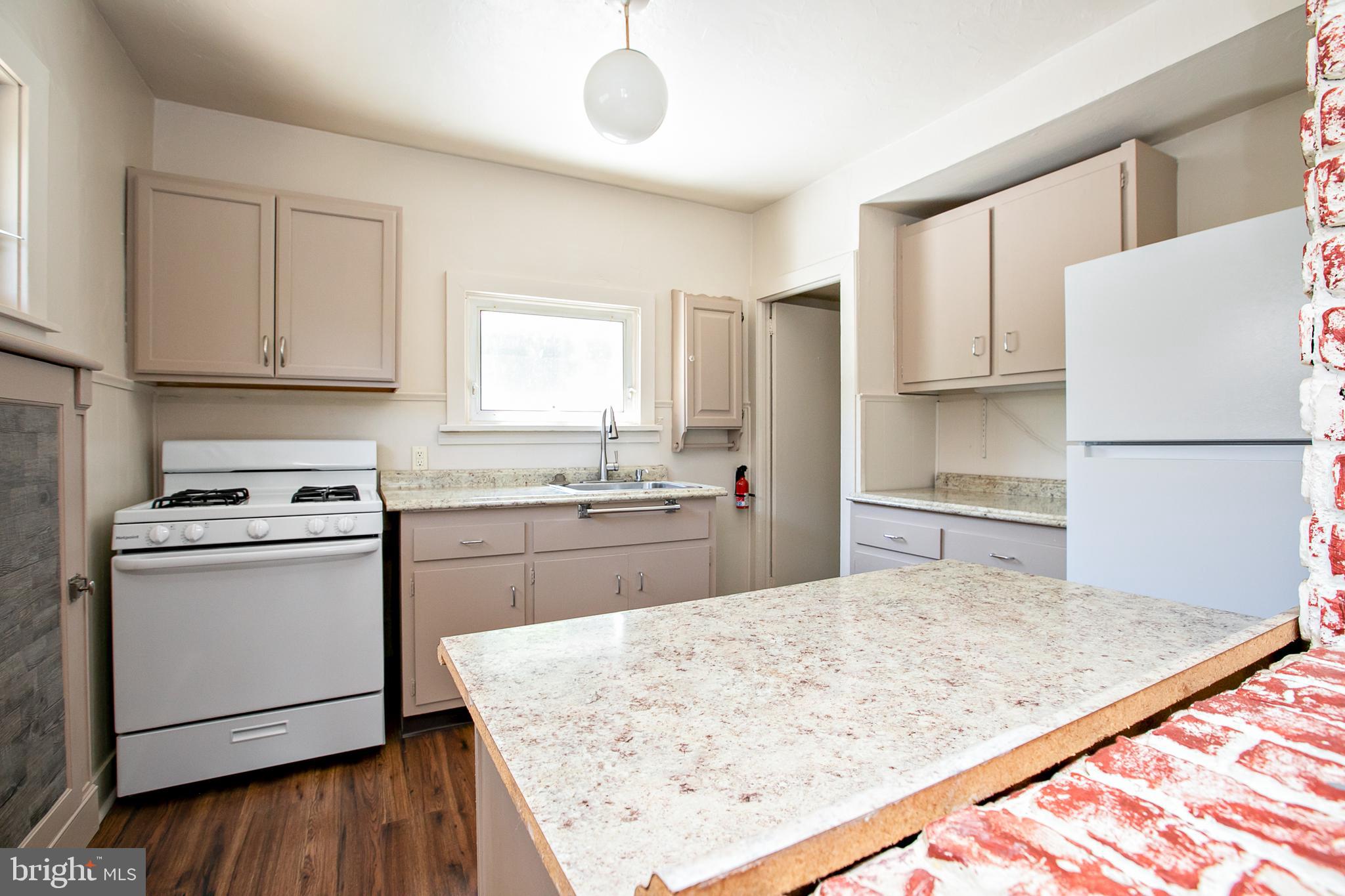 34 Valley Road Mount Ephraim, NJ 08059 - Photo 14 of 39 a kitchen with a stove a sink and a refrigerator