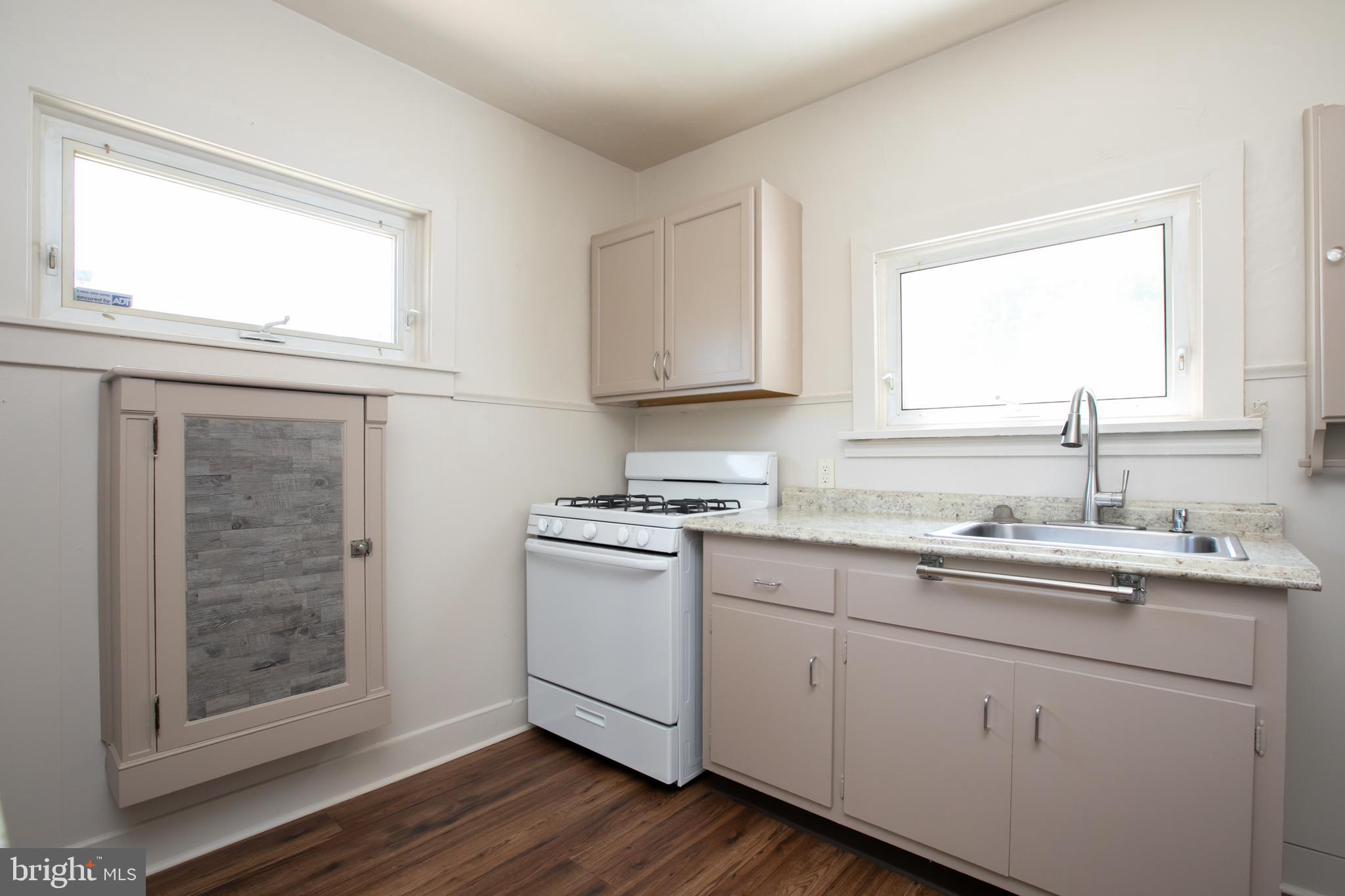 34 Valley Road Mount Ephraim, NJ 08059 - Photo 16 of 39 a kitchen with a sink cabinets stainless steel appliances and a window