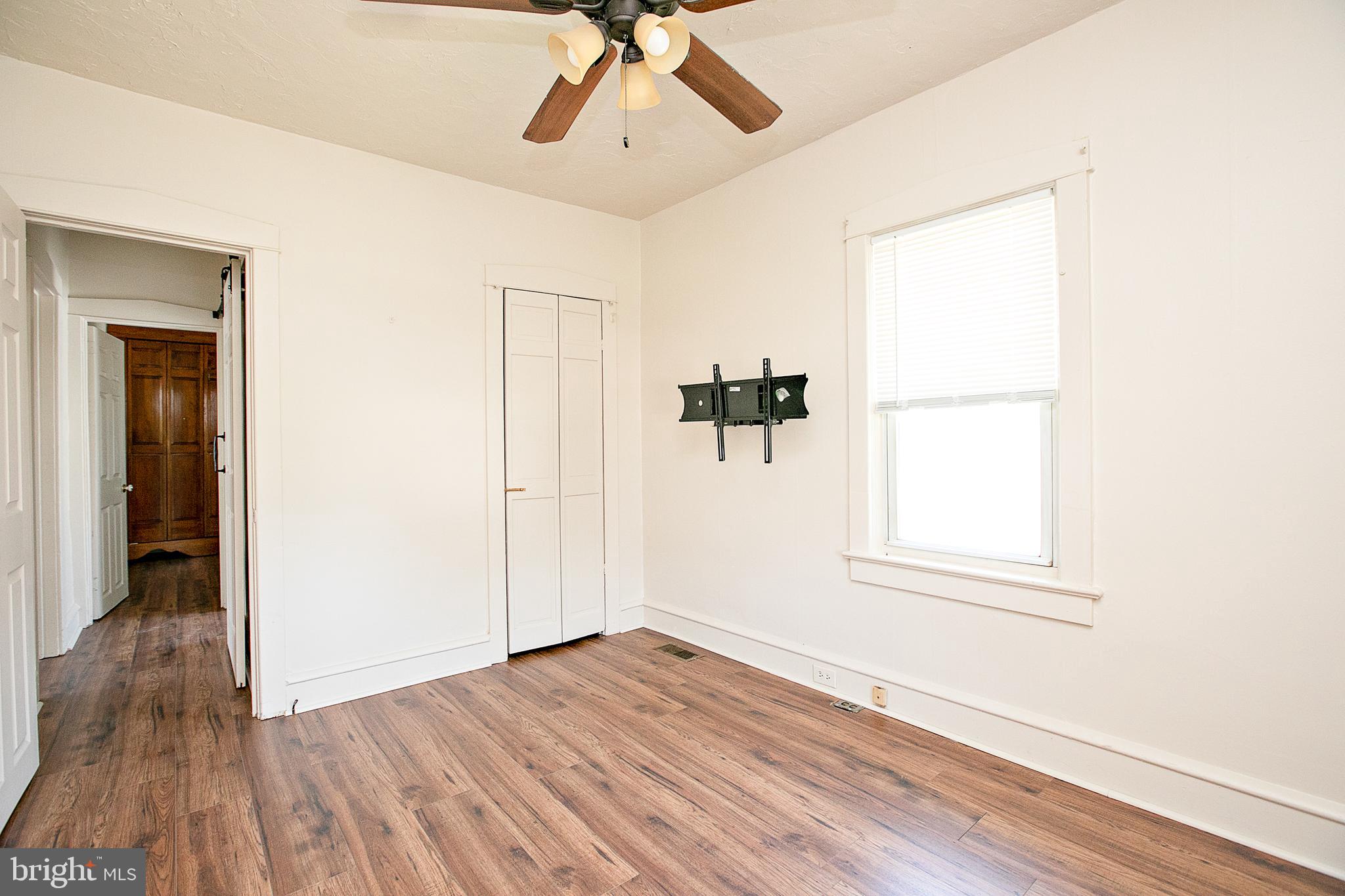 34 Valley Road Mount Ephraim, NJ 08059 - Photo 20 of 39 an empty room with wooden floor chandelier fan and windows