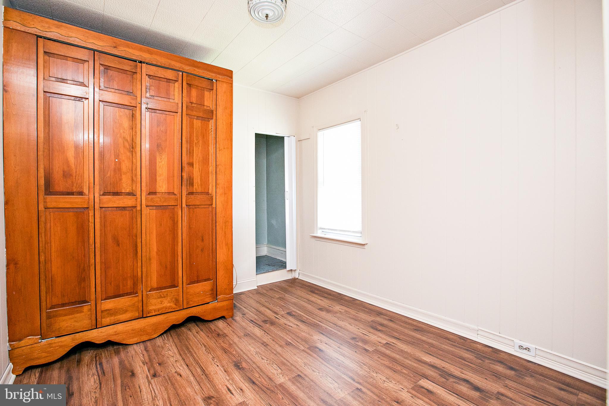 34 Valley Road Mount Ephraim, NJ 08059 - Photo 21 of 39 an empty room with wooden floor and a window