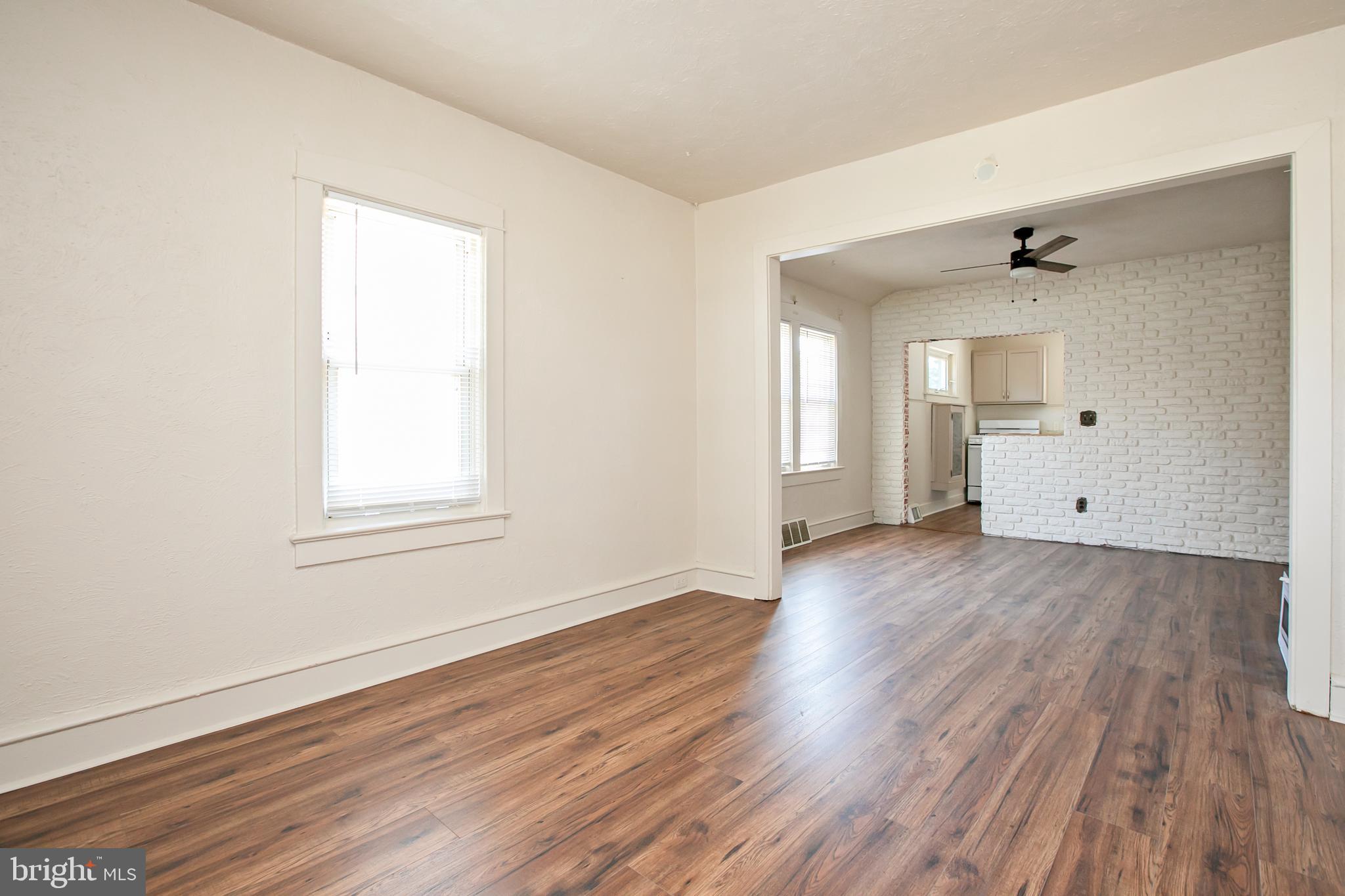 34 Valley Road Mount Ephraim, NJ 08059 - Photo 6 of 39 an empty room with wooden floor and windows