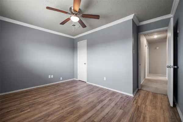 wooden floor in an empty room with a fan