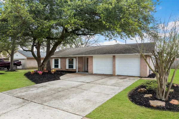 a front view of a house with yard and green space