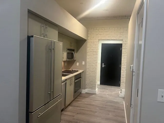 a kitchen with stainless steel appliances granite countertop a refrigerator and a stove