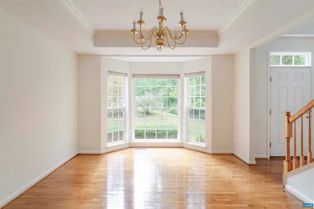 an empty room with windows and fireplace