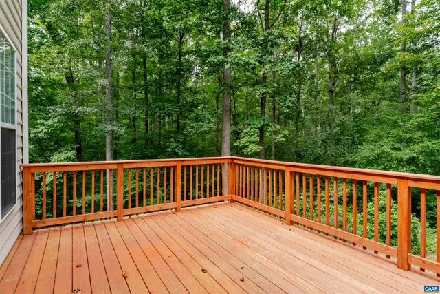 a view of a house with a yard and large tree
