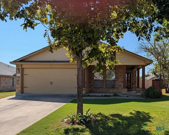 a front view of house with yard and trees