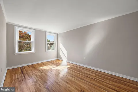 a view of room with window and wooden floor