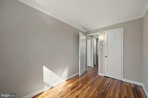 a view of room with window and wooden floor
