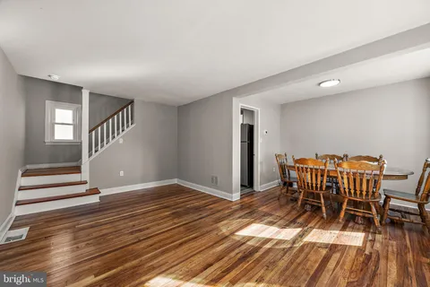 an empty room with windows and a wooden floor