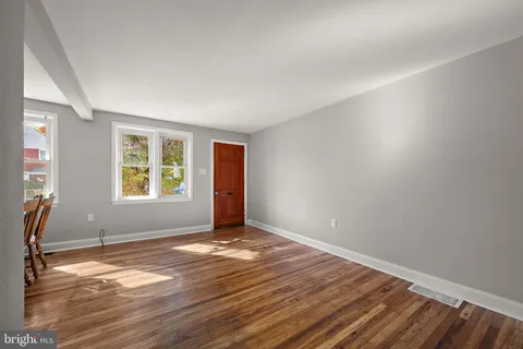 a view of a dining room with furniture and a window