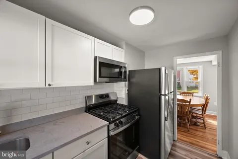 a kitchen with stainless steel appliances a stove a sink and a microwave