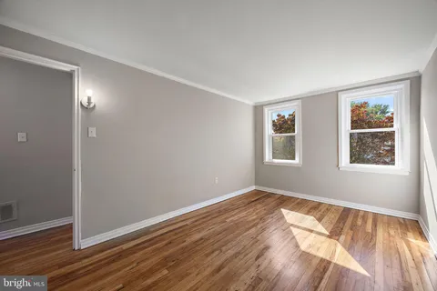 a view of an empty room with wooden floor