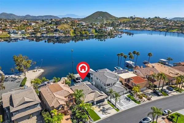 an aerial view of a house with outdoor space and lake view